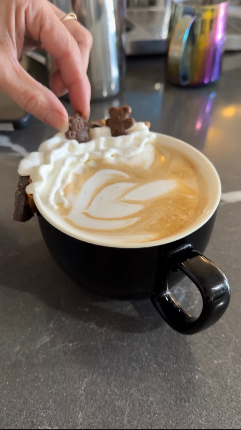 Cookie dough latte with whipped cream, teddy grahams and latte art